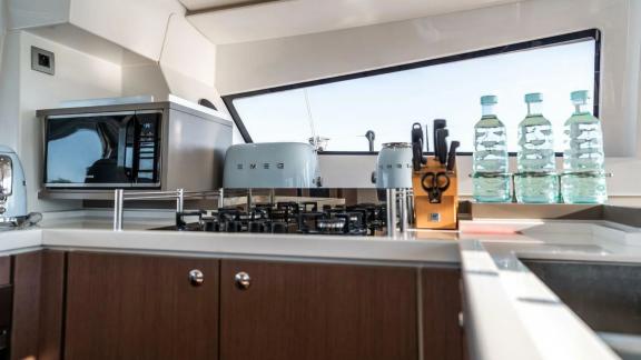 The well-equipped kitchen of the Bali 5.4 catamaran in Italy offers all the amenities for culinary enjoyment on board.