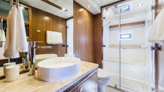 Stylish sink, large shower area, and wooden details on Sirena 64.
