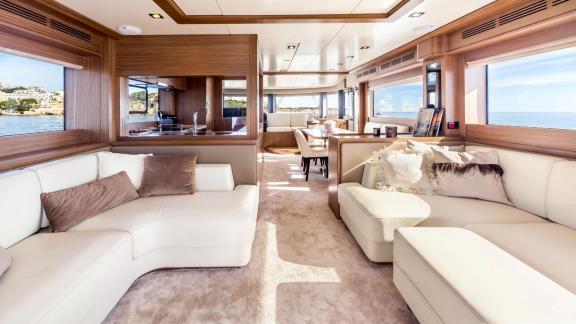 White leather sofas and large windows create a bright and spacious atmosphere on Sirena 64.