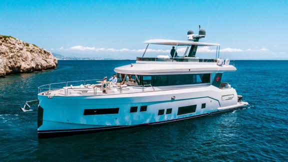 Sirena 64 motor yacht offers a comfortable journey on its spacious deck in open sea.