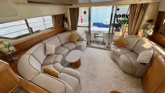 The spacious salon on motor yacht Sky 22 offers a comfortable seating area and sea view.