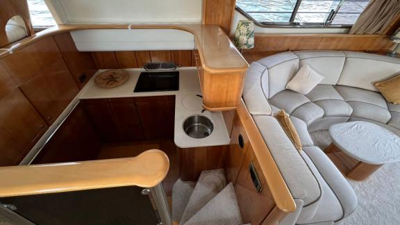 The spacious salon on motor yacht Sky 22 offers a comfortable seating area and sea view.