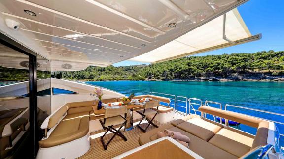 Cozy dining area on the aft deck of motor yacht Spice of Life II, relaxing in the calm waters of Croatia.