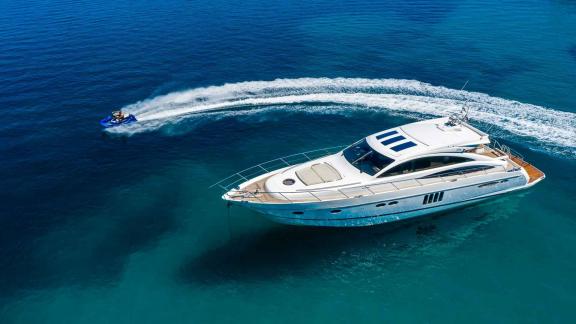 The motor yacht Spice of Life II is anchored in Croatia, client enjoying a jetski ride in the blue sea.