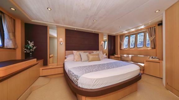 The spacious bedroom of motor yacht Spice of Life II offers comfortable and luxurious accommodation.
