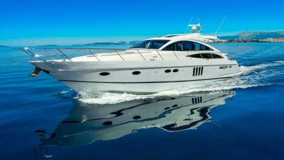 The motor yacht Spice of Life II is cruising in calm waters off the coast of Croatia.