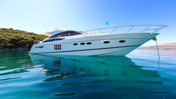 The motor yacht Spice of Life II is anchored off the coast of Croatia, resting in clear waters.