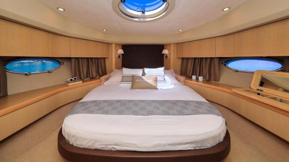 The spacious bedroom of motor yacht Spice of Life II offers a sea view and luxurious accommodation.