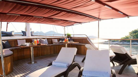 On the gulet Cataleya, which has 9 cabins and is moored in Croatia, cosy sun loungers and a shaded dining area invite yo