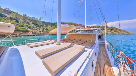 The Gulet Kasapoglu 6 offers comfortable lounging areas for sunbathing with views of the scenic coastline.