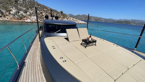 Foredeck of Fundamental B with comfortable seating area and sea view.