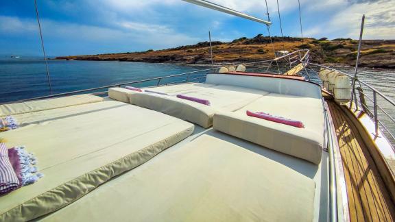 Spacious lounging areas on the sun deck of Gulet Cagan 2, perfect for relaxing under the sun with views of a tranquil co