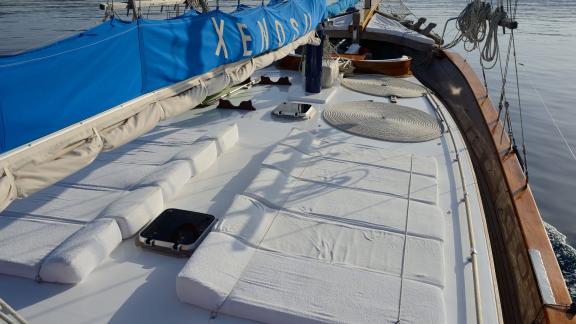 Comfortable sun deck of Gulet Xenos 2 in Bodrum with cushioned loungers and a relaxing atmosphere.