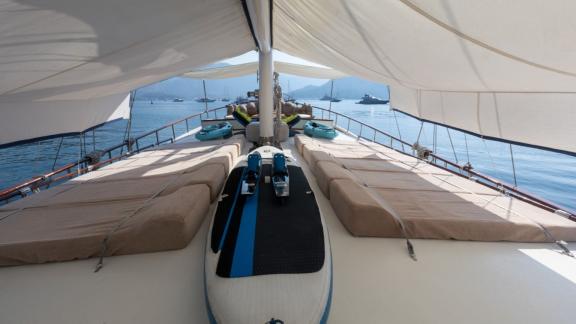 Relax in the shade on the deck of Yacht Kanarya, equipped with comfortable lounging areas.