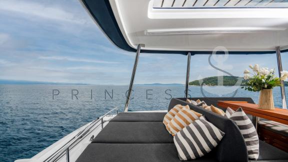 Cozy relaxation area on the flybridge of the catamaran Princess S with a sea view near Hvar, Croatia