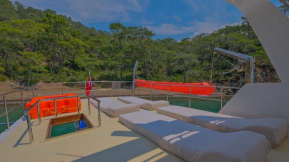 Spacious sunbathing area on the trawler Grainne Mhaol with nature views.