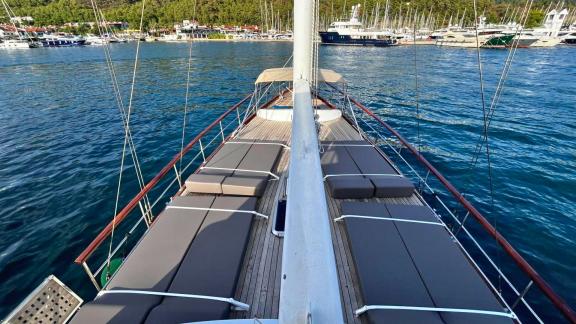 The foredeck of Gulet Ahmet Ertürk features sun mattresses and a wooden deck.