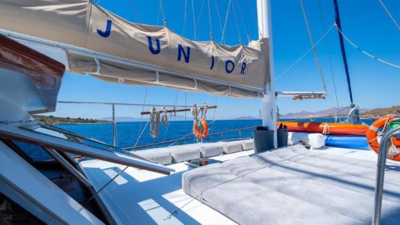 Sunbathing area on the deck of Gulet Cemre Junior with a sea view.