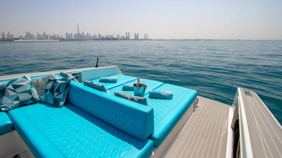 The Lucky Me yacht offers luxury Dubai yacht rental with a cozy blue-themed bed area and stunning views.