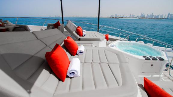 The sunbathing area with a jacuzzi on the Legende motor yacht adds comfort and luxury to your Dubai yacht rental experie