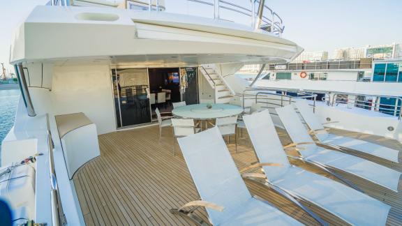 The spacious deck of the Lucien motor yacht offers a luxurious relaxation area for hourly yacht rentals in Dubai.