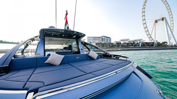 Enjoy the tranquility of the sunbed area on Pershing 5X Grey with hourly Dubai yacht rental services.