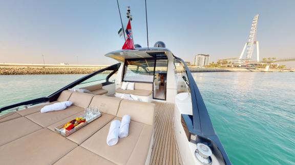 Pershing 5X White offers a spacious and comfortable sunbathing area for daily yacht rentals in Dubai.