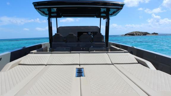 Aft deck sunbed of daily motor yacht Bambino near Ibiza coast.