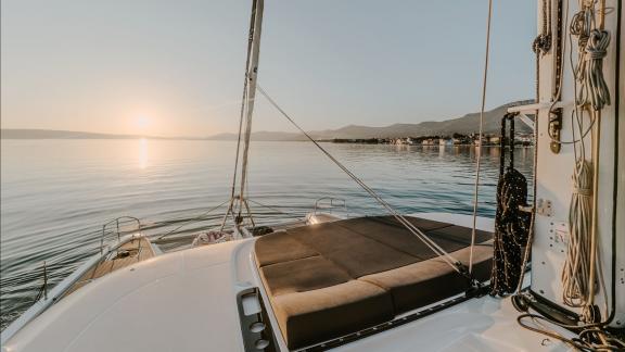 The Lagoon 55 Tri Wing offers serene sunset lounging on the bow with views over the calm Kastela bay.