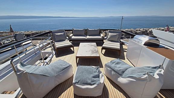 In Sibenik motor yacht charter option First Horizon upper deck with seating group and table visible.