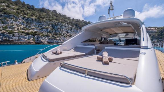 An Ibiza, Spain motor yacht charter lets you relax on the spacious deck of the Freedom while soaking up the Mediterranea