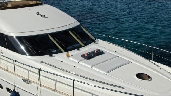 Relaxation area with drinks on the deck of the yacht Azure, overlooking the sea.