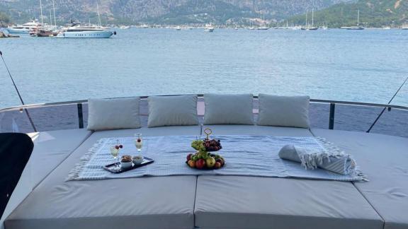 Aft deck of motor yacht Serpil D with fruits and drinks on the table.