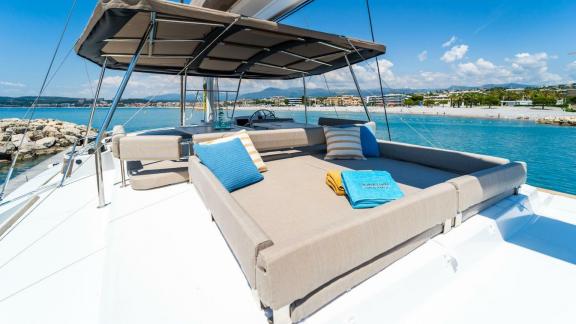 The luxurious lounge area of the Bali 5.4 catamaran offers stunning views of the Italian coastline.