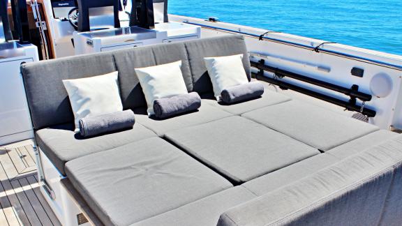 The spacious sunbed-style seating area on the motor yacht Celebrate is perfect for sunbathing and relaxing.