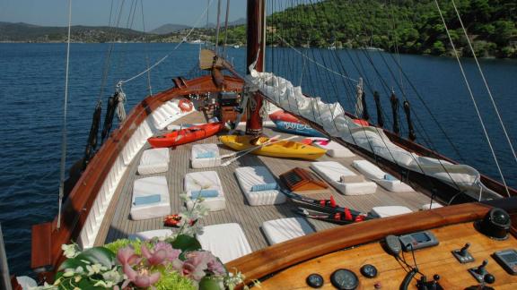 The spacious deck of the Gulet Matina in Greece is equipped with sun loungers and kayaks