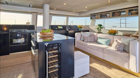 The spacious salon of Adara yacht combines a cozy lounge with a modern kitchen.