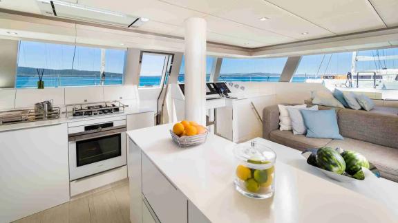 Inside Sunreef 50 Solitaire is a stylish kitchen, cozy seating area, and panoramic views over the Kastela marina.