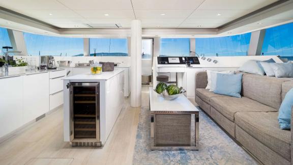 The modern saloon of Sunreef 50 Solitaire features an open kitchen and panoramic windows for a bright atmosphere.