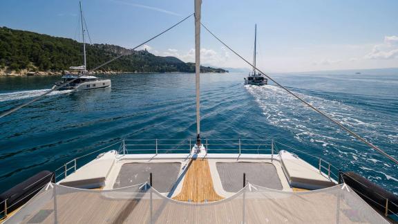 In Kastela Zara’s front deck shows netted lounging area with sea view and passing yachts.