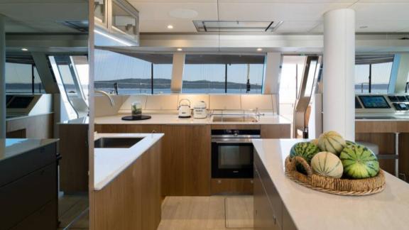 In Kastela Zara’s kitchen features stove oven wide counters and sea view through windows.