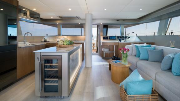 In Kastela Zara’s saloon features a kitchen island sofa and large windows with sea view.