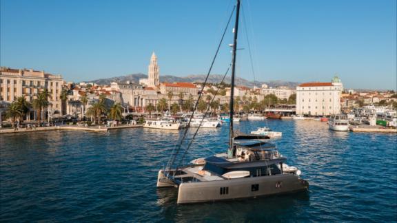 Ahalya charter Sunreef 60 catamaran is anchored close to historic Kastela harbor.