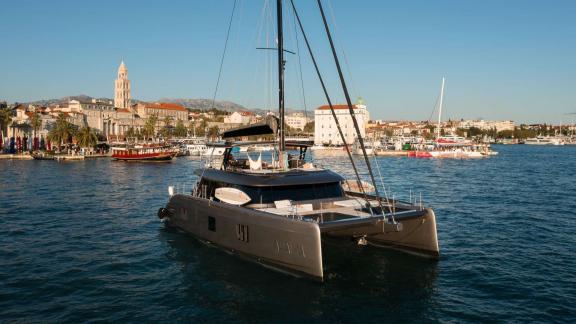 Ahalya charter Sunreef 60 catamaran stands out near the historic coast of Kastela.