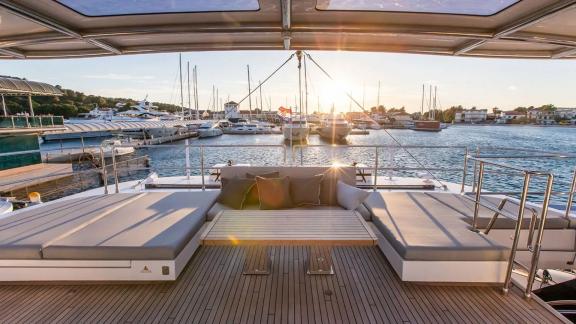 Relax on the flybridge of Sunreef 60 Mr. Si while enjoying the sunset over the marina and luxury yachts.