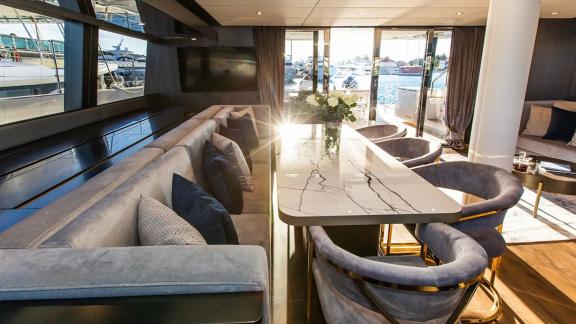 The marble dining table and wide windows aboard Sunreef 60 Mr. Si offer a refined and bright dining experience.