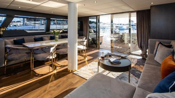 Experience comfort inside Sunreef 60 Mr. Si with modern decor, panoramic windows, and a refined dining setup.