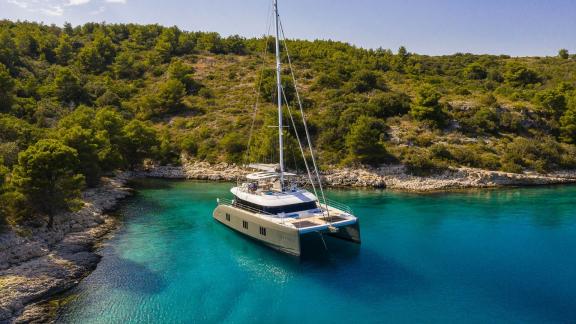 Sunreef 60 Vulpino anchored in crystal-clear waters near Kastela.