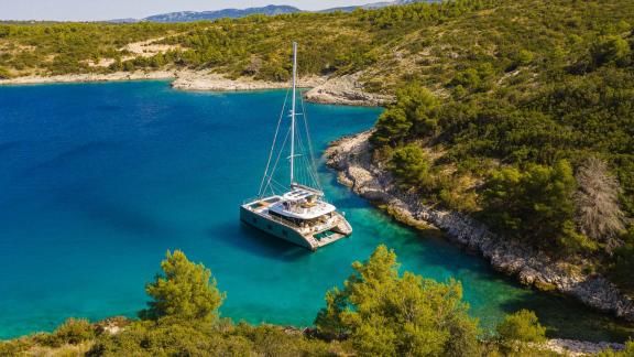 Sunreef 60 Vulpino anchored in a quiet, nature-surrounded bay near Kastela.