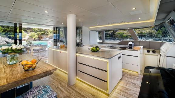 Inside Vulpino in Kastela there is a sleek kitchen with a large counter and dining area.